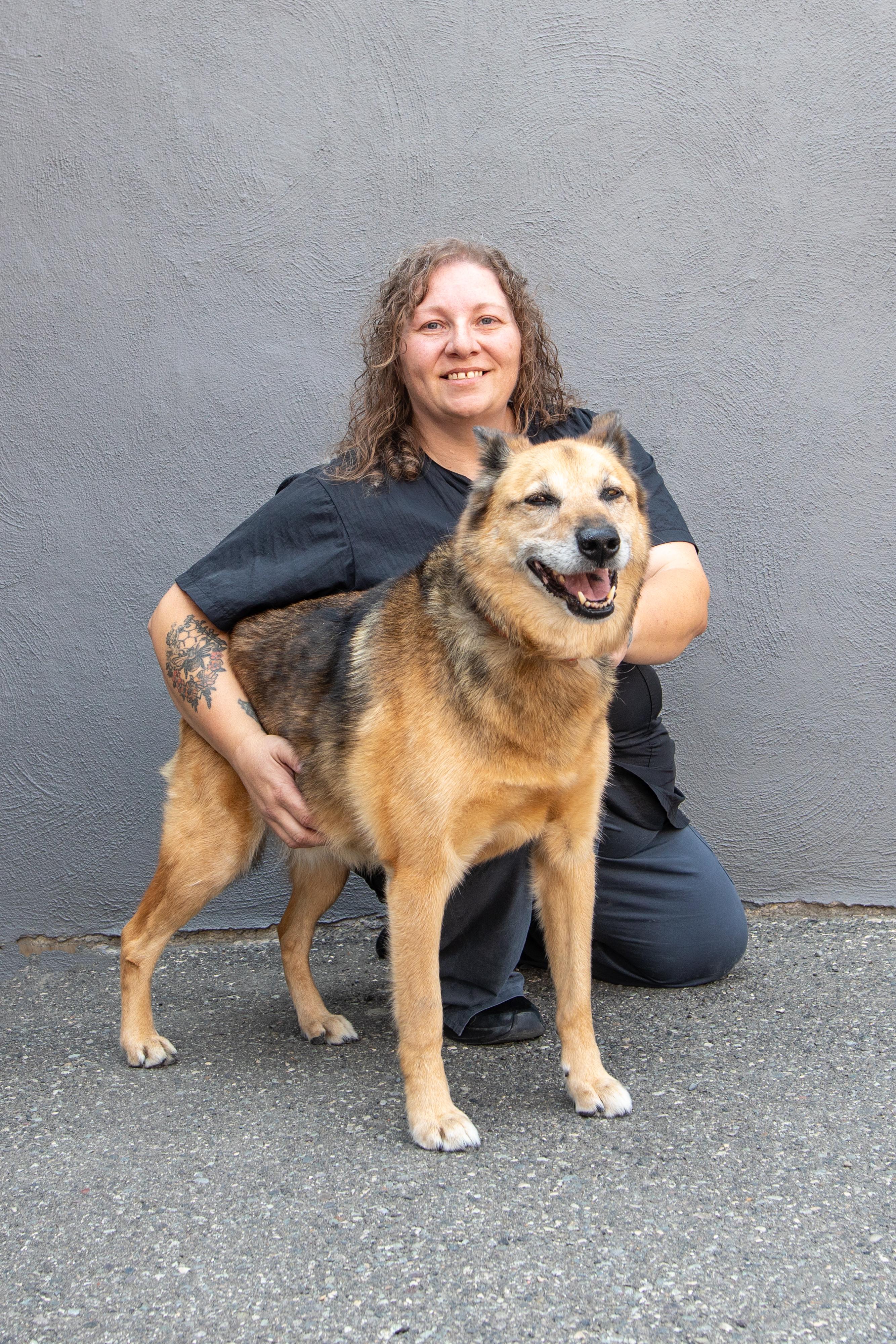 Jenny with a large dog, showcasing her role as a trainer and groomer